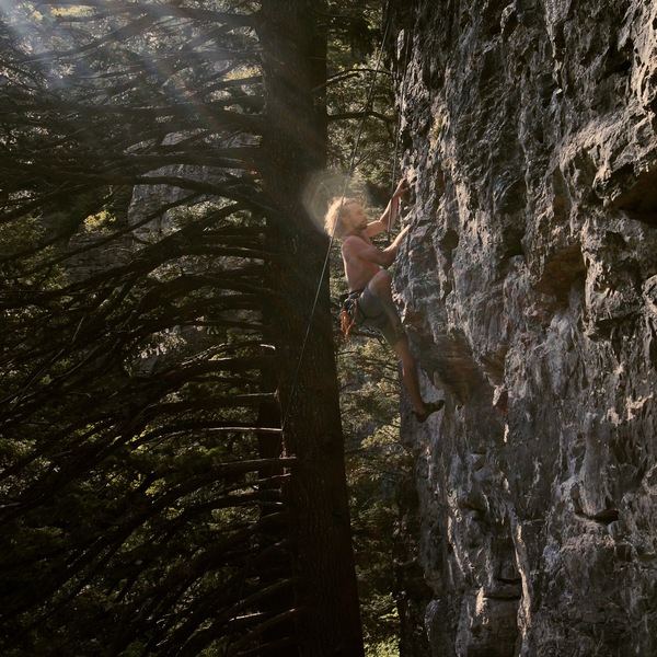 Keir L.B. moving to the positive holds above the balancy roof on Vaporous Apparition.