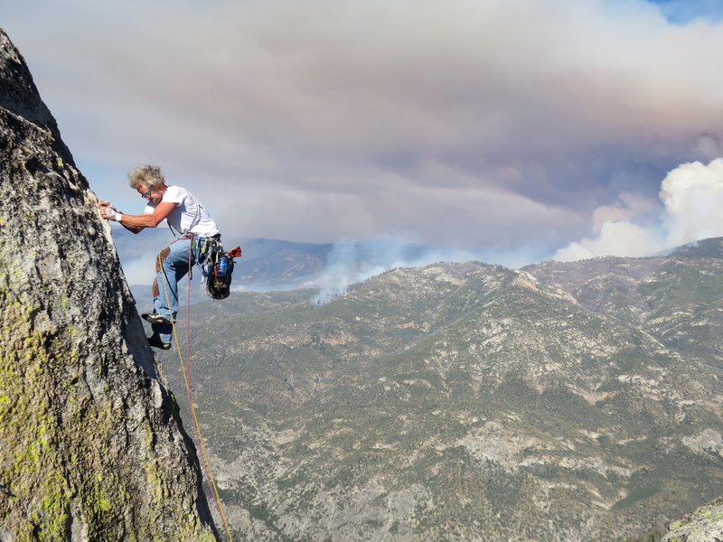 Dow climbing the arete to the top of the Main Summit of The Warlock. There are 2 bolts to protect the arete. This is the last part of Imaginary Voyage. (Forest fire—"Schaeffer Fire"—burning in background.)