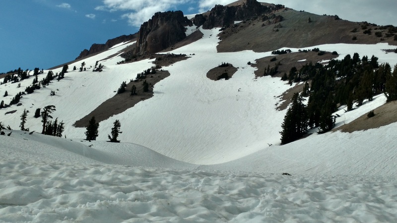 Southwest face leading to summertime trailhead. Note the ice chunks comprising streaks that may be visible with effort.