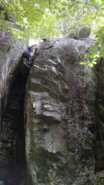 This is an easy, dirty and enjoyable climb in the crack to the anchors.  It's safe to TR and is probably a7 if you climb chimneys or an 8 if you don't.  An option if you have someone in your group that cannot climb a 10c.<br>
<br>
Social Obligation is the face climb to my right.