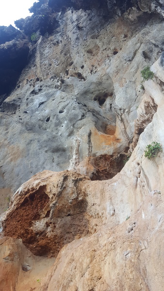 Affenhitze follows the right line of chalked holds out of the two "eyes" and up the steep wall.