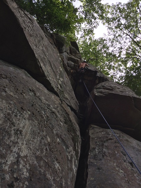 Pulling the roof the hard way. If you don't like the inversion, you can just use the rocks to the left. It'll be a great route if people start climbing it and clean it up a bit.