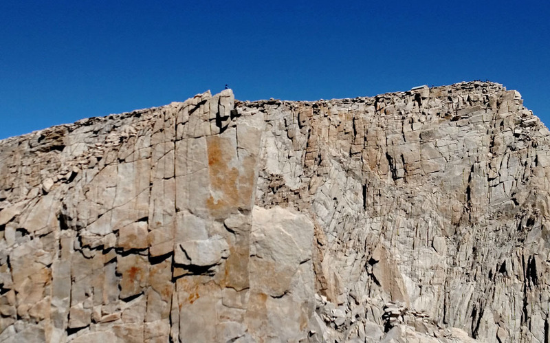 scrambler on summit of Keeler Needle,
<br>
with Mt Whitney summit and its building behind right