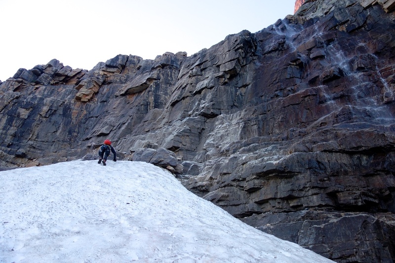The route starts by climbing through the quartzite cliff just left of the waterfall (at the top of the snowfield in the photo).