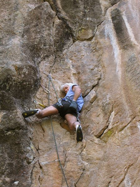 An unlikely rest position before the hard bridging begins. Two stoppers and a tri-cam protect these moves.