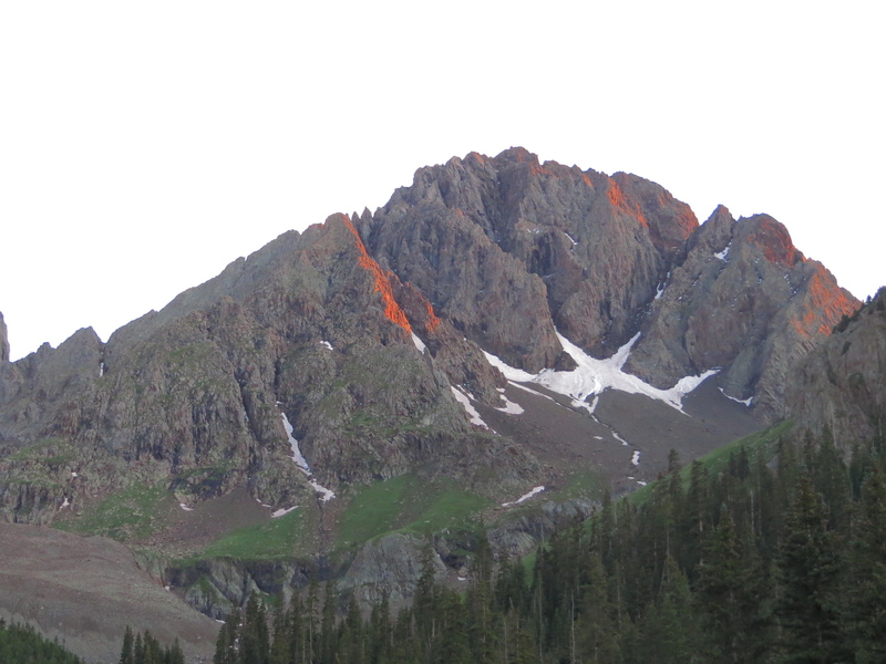 "Northeast Buttress?" (5.8), left of center, highlighted with alpenglow.