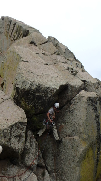 Starting up the SE Arete. You can put a 0.3 Camalot C4 in the crack above my head in this photo to really protect the first move.