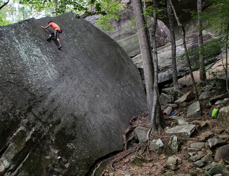 Elliot Yoakum delicately placing his foot before the final move on Yosemite Slab.