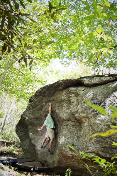 Chris Grasinger standing tall on "Salute" at the Roadside Boulder, Left Boneyard, GHSP