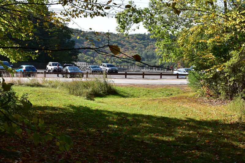 View of the clearing and parking lot seen from the trail used to get to the boulder.