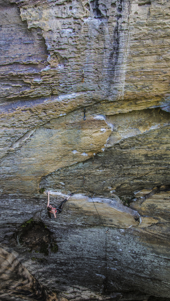 Lydia down low chalking up before the crux. This shows the scale of this incredible line.