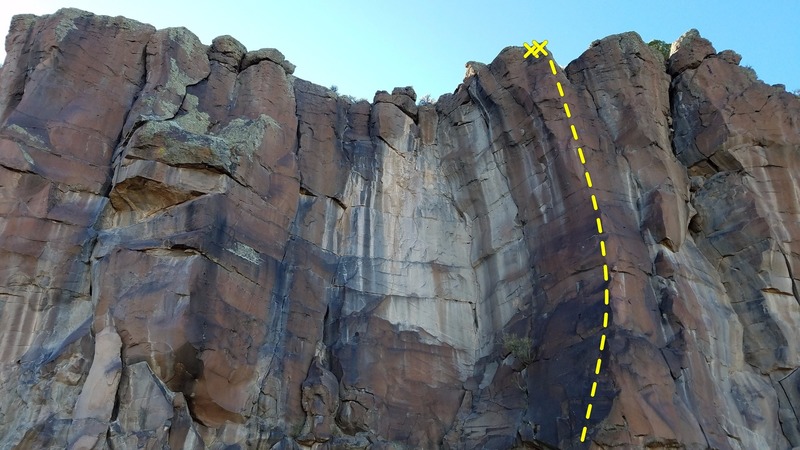 Climb the arete to the right of the large white section of the wall.