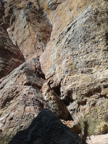 Mike is at the first anchor station on Jorgie's Crack. The route follows the dihedral to the right of him. The red rope on the left is on Swallow Crack.