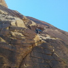 Pitch 8. Step right from the chains, head up to the right side of the roofs, then drift left and up to the belay ledge.