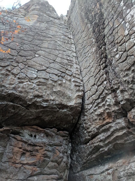 Climb the left face up to the roof then stem out and fist jam your way through the roof crack to reach the first jug. Once your hand is on that first jug, this route is over. It is 5.7 climbing up the slightly less than vertical face on dinner plate jugs.