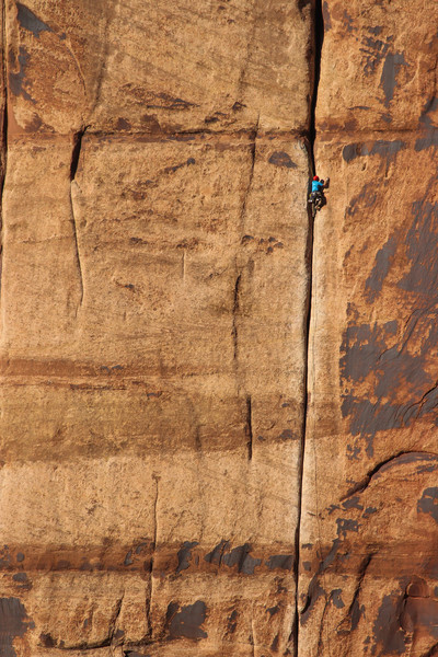 Climber at the top of Generic Crack shot from the far left side of Super Crack Buttress