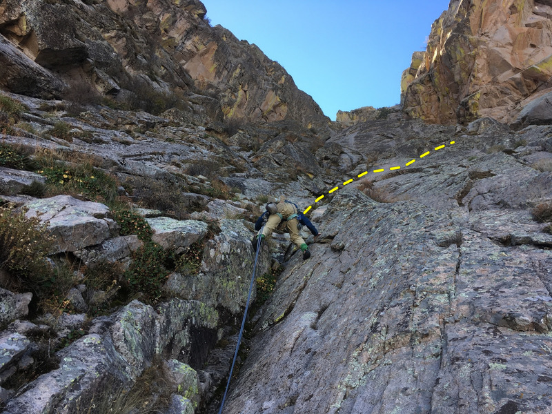 Marta Reece leading P3, with path shown. This pitch can be led/climbed on the cleaner rock to the right.