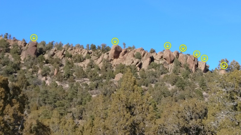 The view of Sprocket Rocks from approach. Arrows mark the spots with routes.