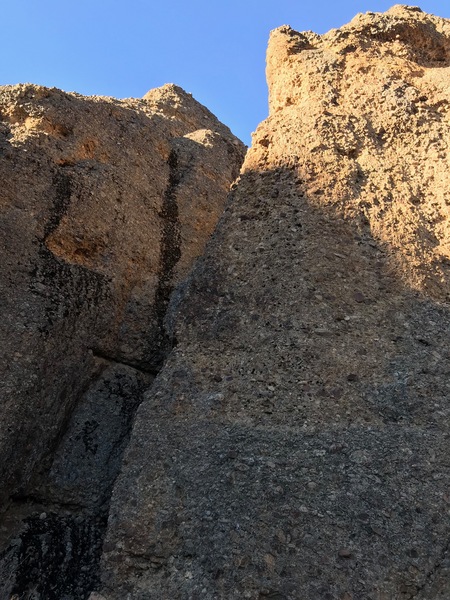 Bullets over Baghdad follow the prominent arete rising from photos lower left to upper right. Ends at a set of Metolius rap anchors at the ledge below the summit cone.