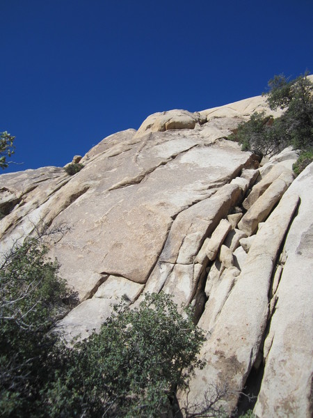 Dyke Stretcher goes up the smooth brown face to the dyke, left of the cracks.