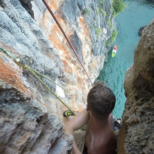 Awesome climbing on the first pitch. Kayak tethered below. The red rope present was donated as a final rap line to make it so you don't have to pull your own rope(keeping it from dropping into the sea water below and getting wet).