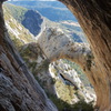 “Admiring The View down Valley from inside the highest cave at El Forat dels Lladres.” 