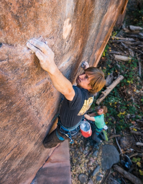 Damon Vaughn sticking the crux hold on Riptide. Photo by Jack Lester.