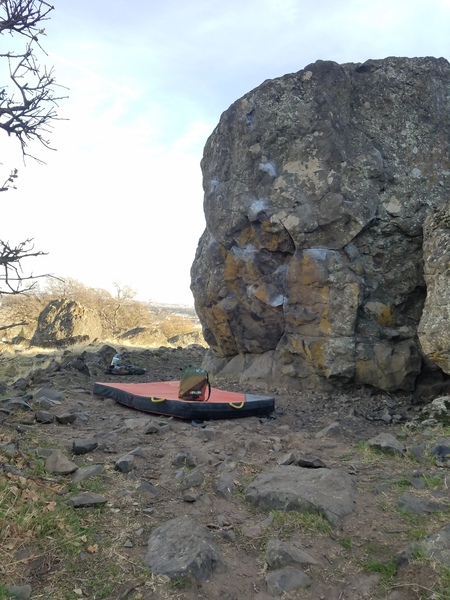 A different view of the boulder problem. Facing the cave, there is a tiny boulder in between the 2 big boulders. Start on the big undercling,on the left boulder. Throw to good sloper pinches and a left hand crack.