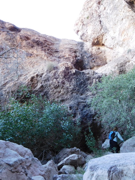 Looking up at the large, dark hueco and the real rock climbing on the route.