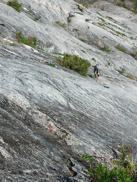 Shot of the belay station mid way up you climb past some strange moves before traversing to climbers right.