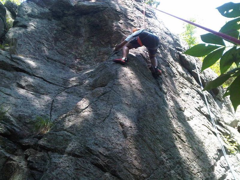 A client attempting to traverse to the false arete climb.
