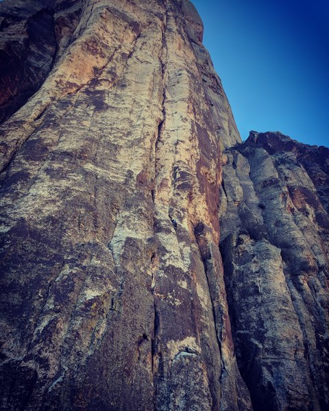 Climber nearing the top of the 1st pitch of Crimson