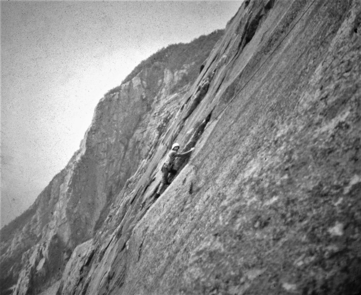 Henry Barber traversing onto the great flake section above Labyrinth Wall and the VMC First Ascent 1973 In the background The Whitney Gilman Ridge