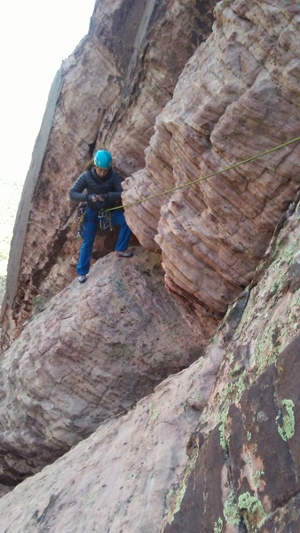 Showing our topout traverse.  I believe the varnish behind the climber is the original line (traversing left instead).