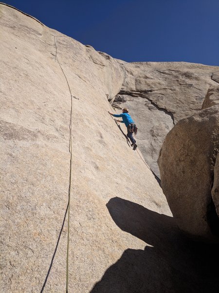Contemplating the crux moves between the first and second bolt.