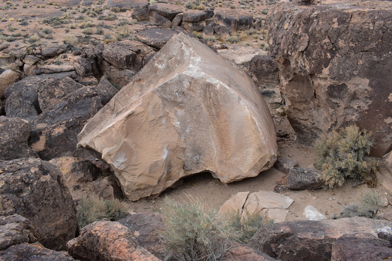 The large uphill face of the boulder.