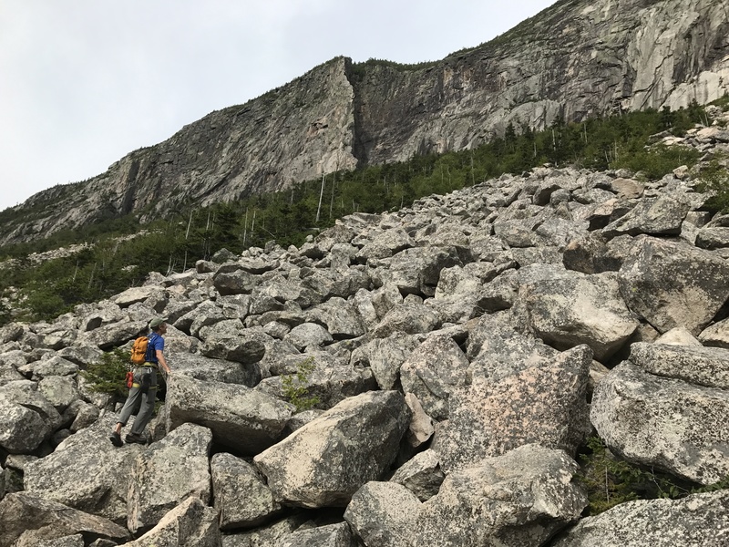 Jim Shimberg crosses the talus en route to the Whitney-Gilman ridge on Cannon Mountain.