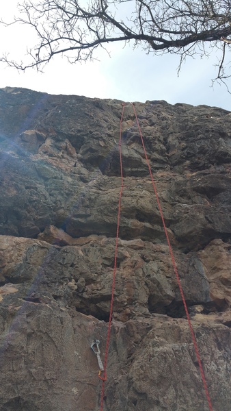 Grapefruit-sized loose block up and right of third bolt - marked with faint chalk X as of 03/25/2018.