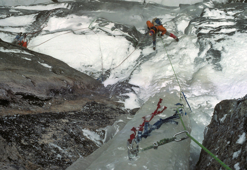 Rainsford Rouner cleaning the 3rd pitch of Remission on the FWA in Jan 1976. The pillar was so narrow and free standing that even swinging an axe made the whole thing vibrate. So rather than back off, I aided the pitch and belayed where it went into the chimney and became alot more solid. Rains took over after that and lead the final pitch in admirable style.