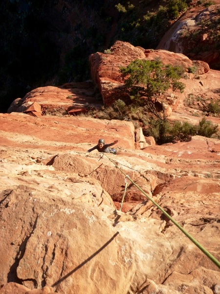 Giselle flashes a friendly wave from midway up the second pitch. Right fork.