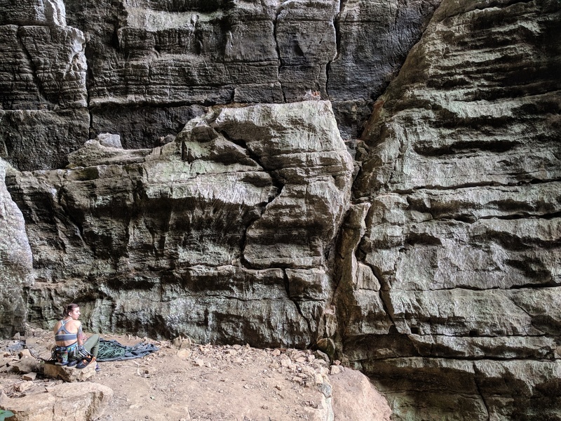 Becky sitting at the base of Seyon (5.10b)