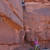 Felix leads the short dual corner crack pitch (our P5) through the Kayenta. We ditched all gear on the ledge above him and scrambled to the top from there. There was a cord on a horn for a short rap back over this pitch.