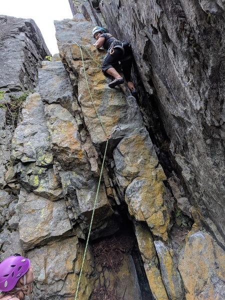 Going up the skinny slot to the 2nd bolt. Not sure if the route creator's intent was to go out left at that point- it seemed possible but would be a lot burlier.