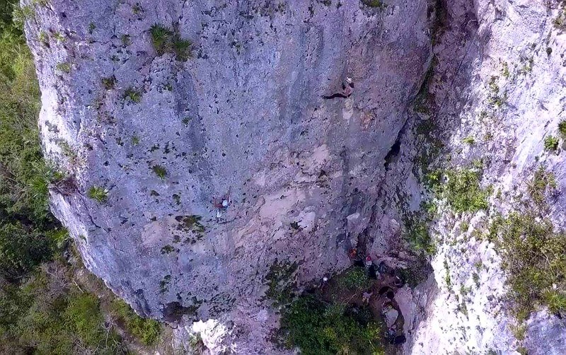 Drone view of the shady wall with climbers on (L) Blanca Nieves "Snow White" and (R) Que Siga La Rumba "Follow the Rumba (music)".