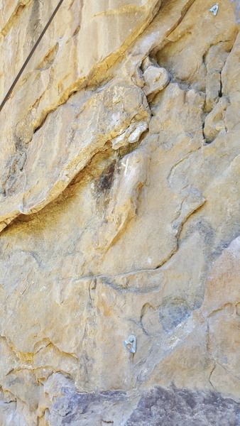 Flakes have broken off below the chalked "X" mark. The two small, heavily chalked flakes above the "X" are also loose, but currently resist attempts at removal.