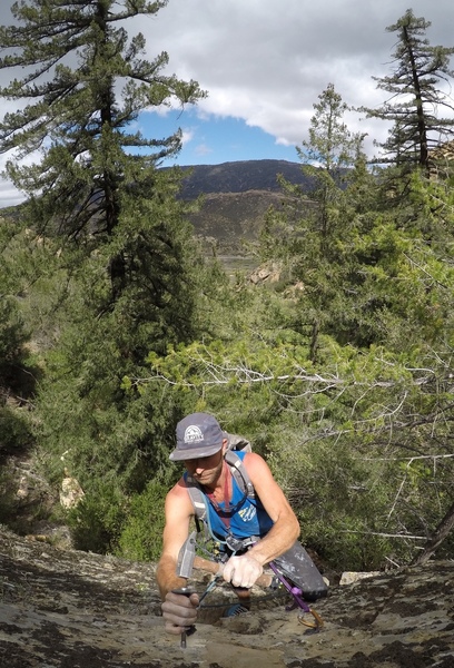 Solo FA on the East Edge of Bigcone Rock. Drilling the anchor after pitch one.