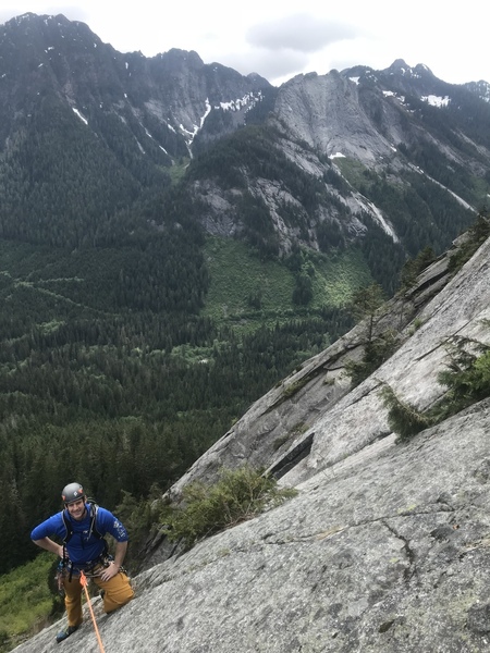 Dan nearing the top of pitch 5, with the view across to Exfoliation Dome