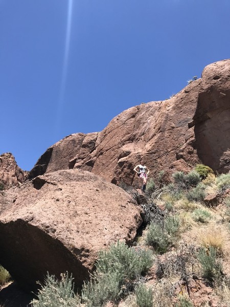 The Little Sheep Wall as seen from the river bed. fiance for scale. The area where you'll set up for belaying is just behind the boulder to the left of my fiance. (now called Contra Canyon Lower Wall)(and also now called my wife :3)