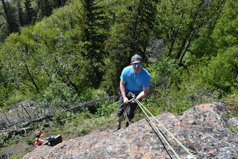 Matt cleaning the route as Darlene and Spenser enjoy a sunny Alaska day in the belay area.