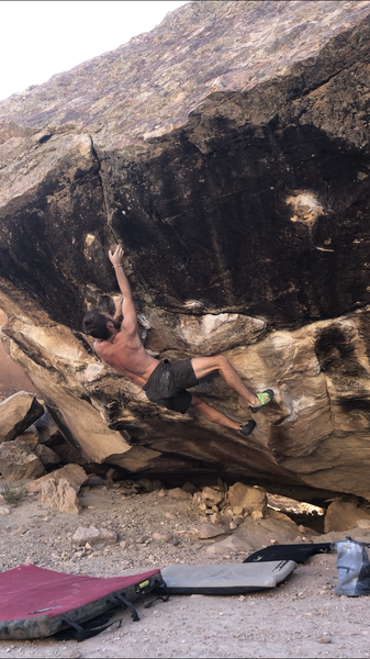Moving into the crux sidepull of Red, V9.